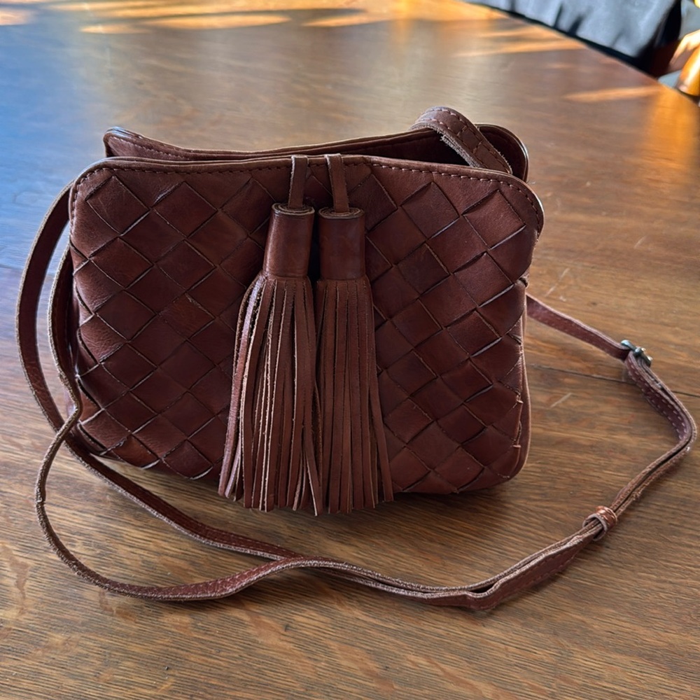 Woven brown leather purse with tassels